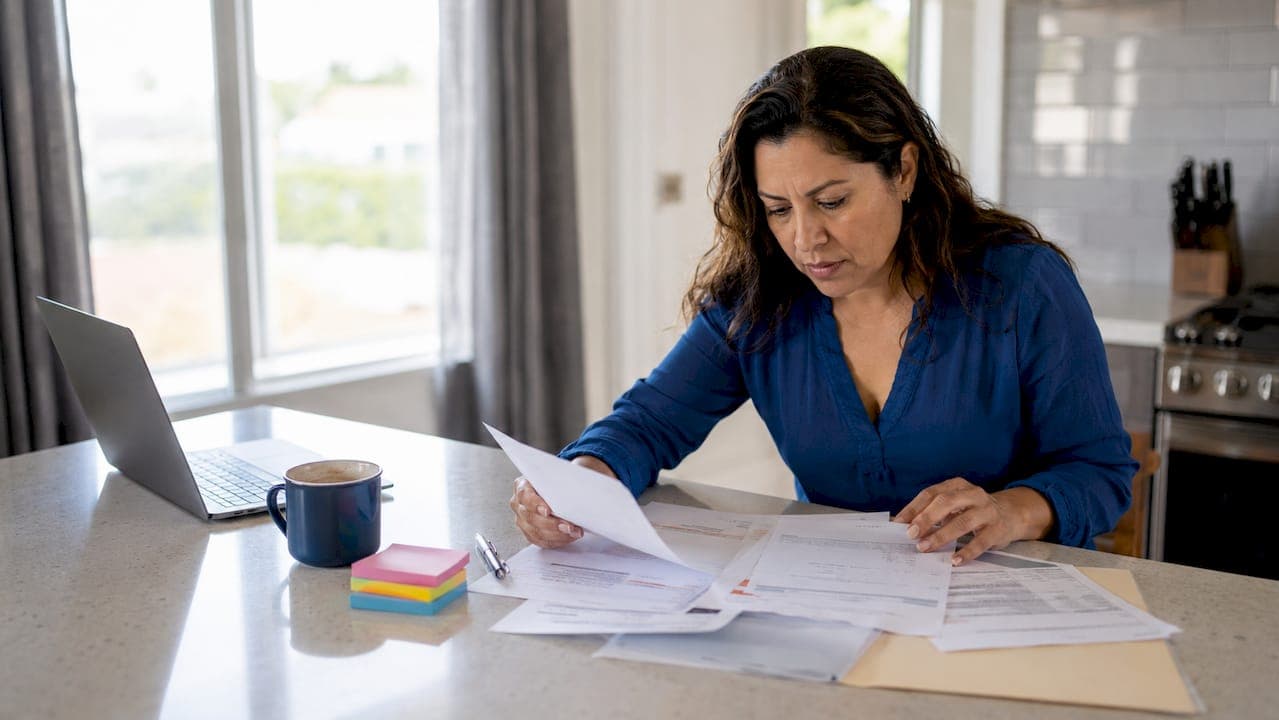 Woman organizing urgent home sale documents